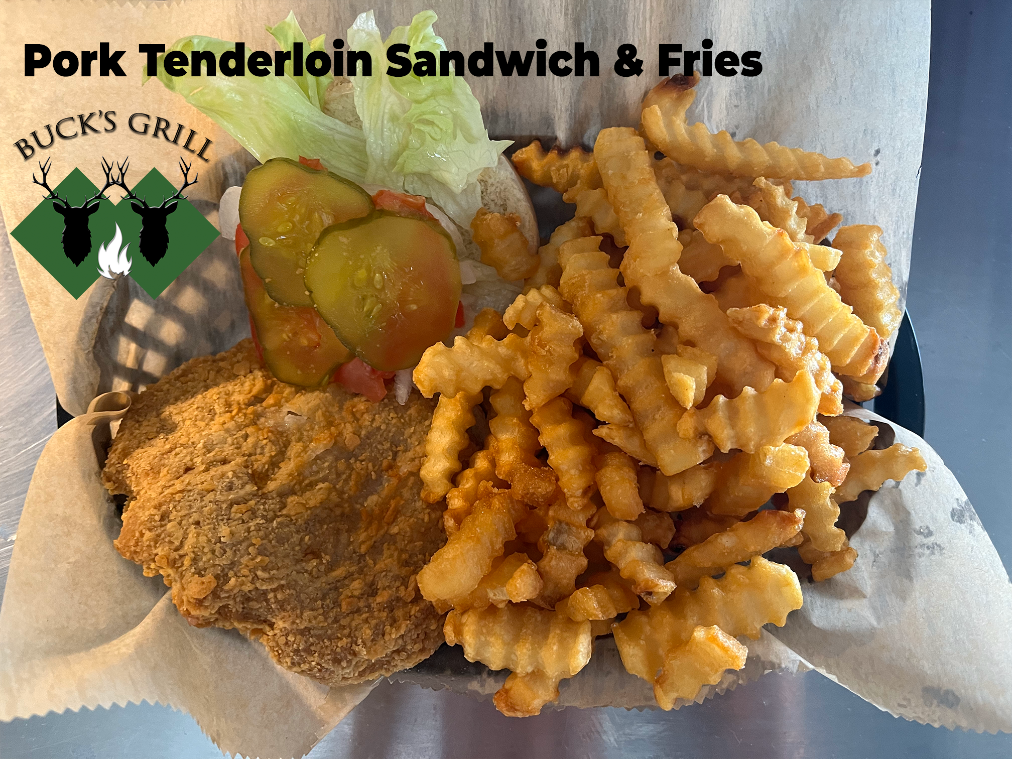 Pork Tenderloin Sandwich and Fries at Bucks Grill